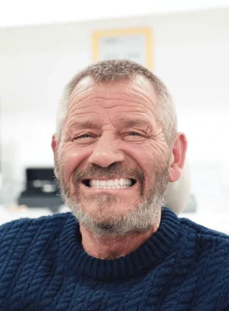 Patient smiling after denture treatment