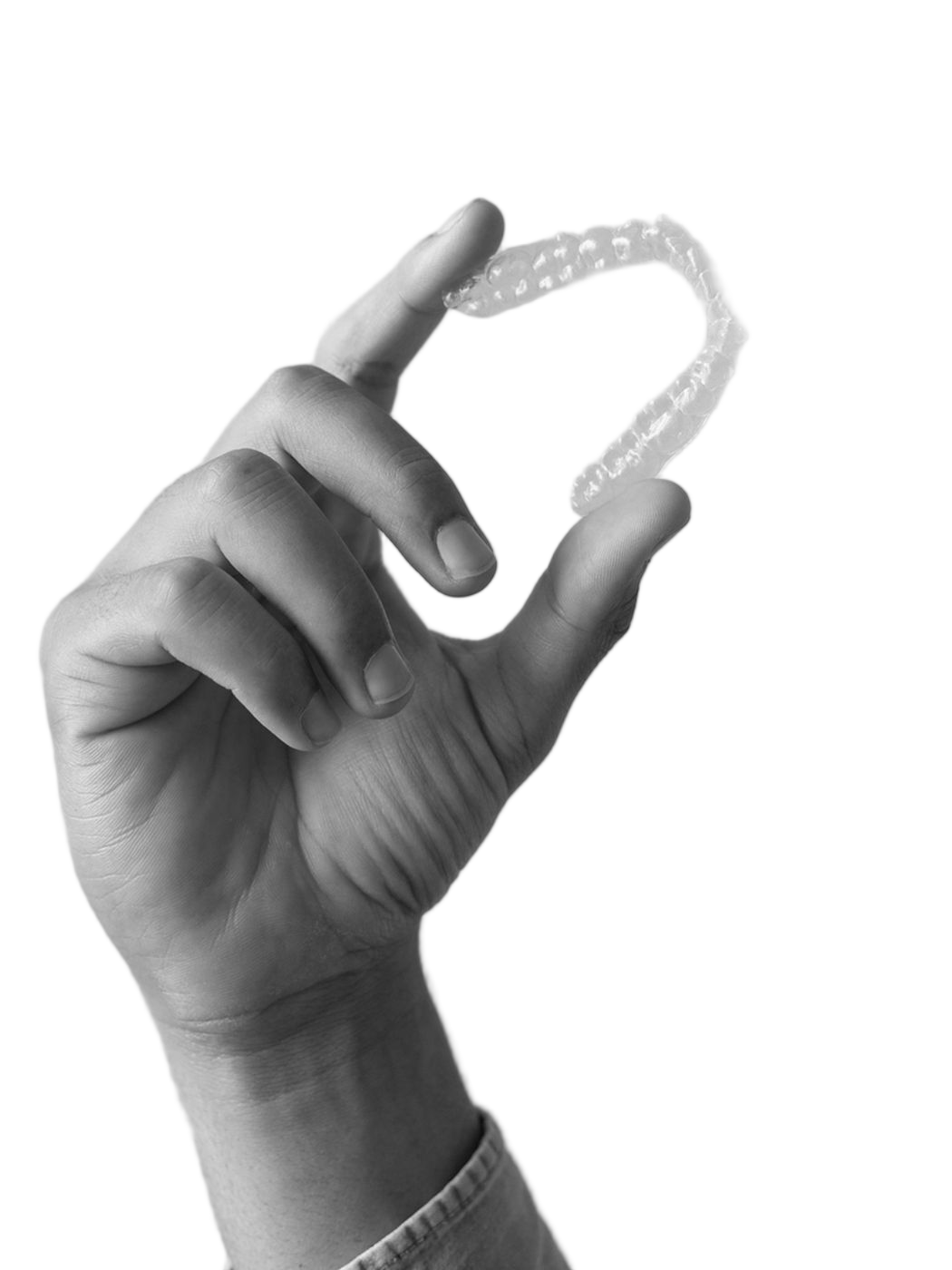 Hand holding Invisalign aligner