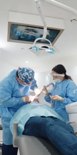 Older female implant patient reviewing her smile