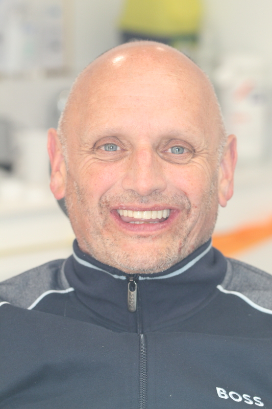 Older patient smiling after full smile rehabilitation